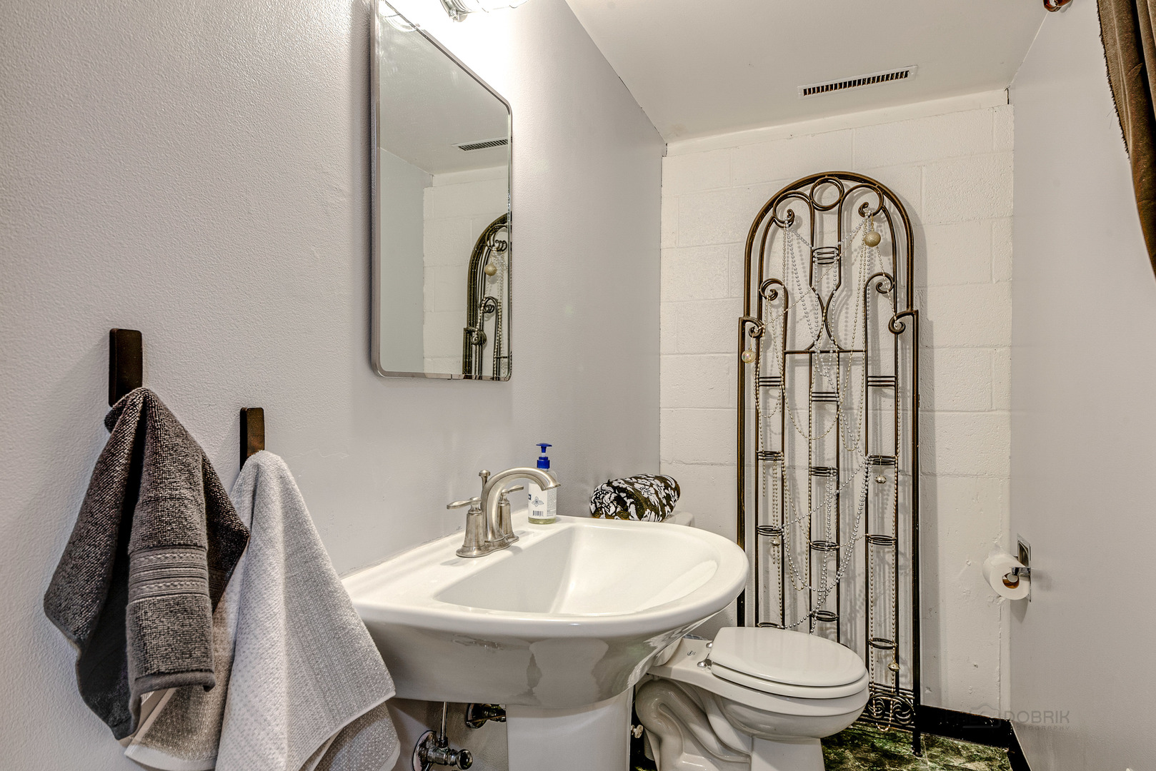 703 Hickory Road Woodstock, IL 60098 - Photo 23 of 33 a bathroom with a toilet sink and mirror