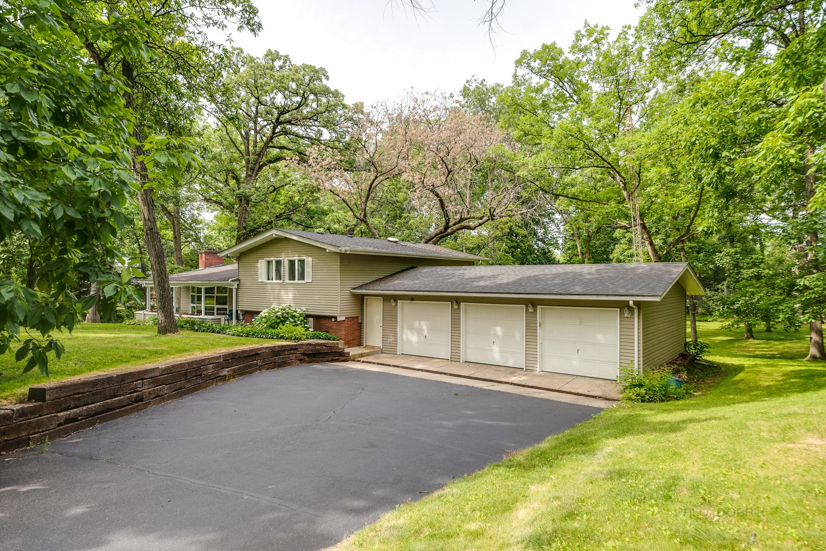 703 Hickory Road Woodstock, IL 60098 - Photo 3 of 33 a house view with a outdoor space