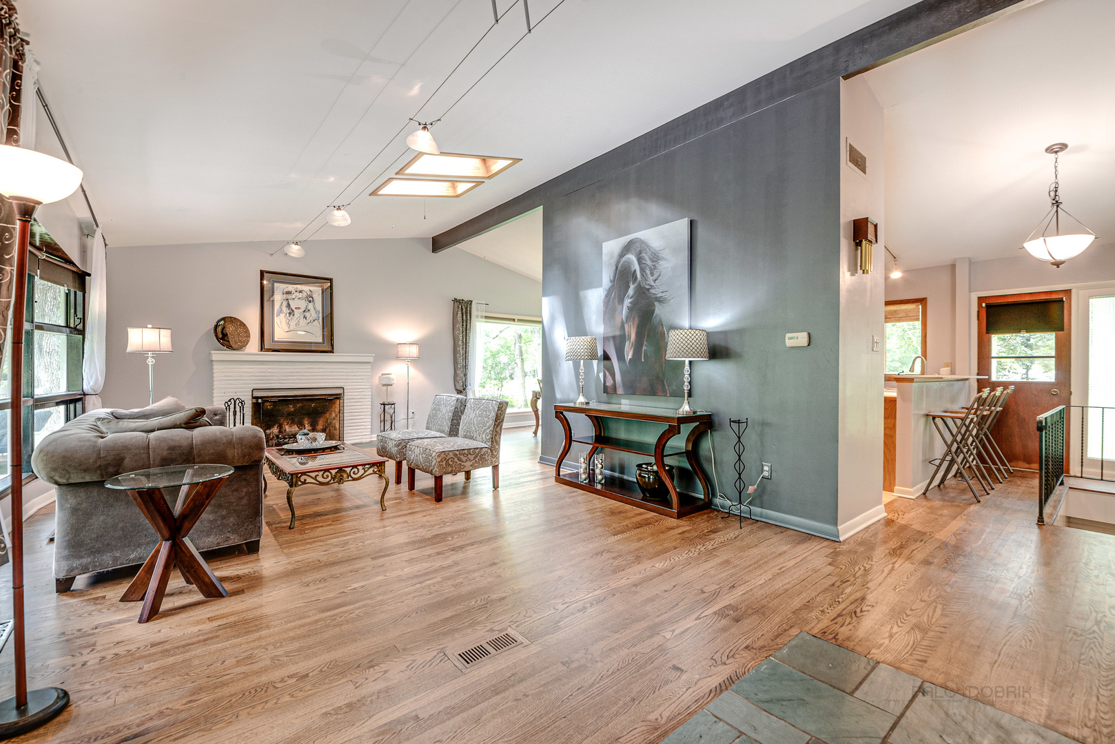 703 Hickory Road Woodstock, IL 60098 - Photo 7 of 33 a living room with furniture and a fireplace