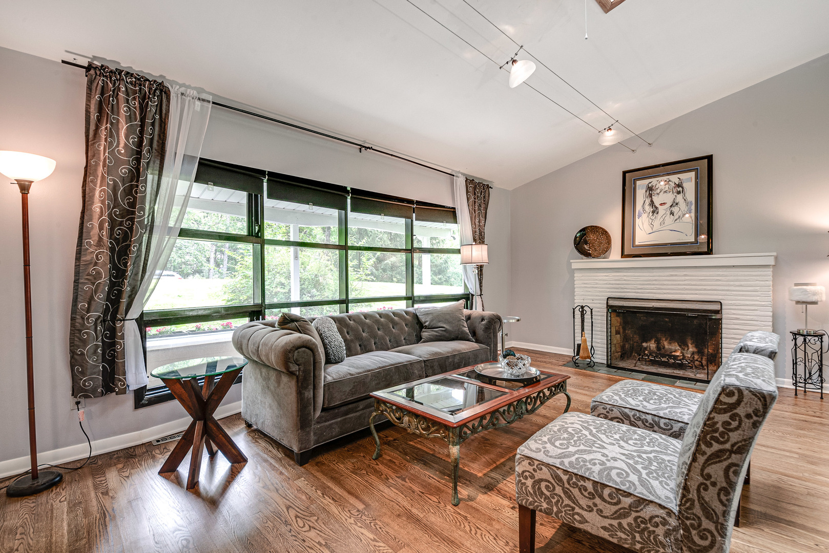703 Hickory Road Woodstock, IL 60098 - Photo 8 of 33 a living room with furniture and a fireplace