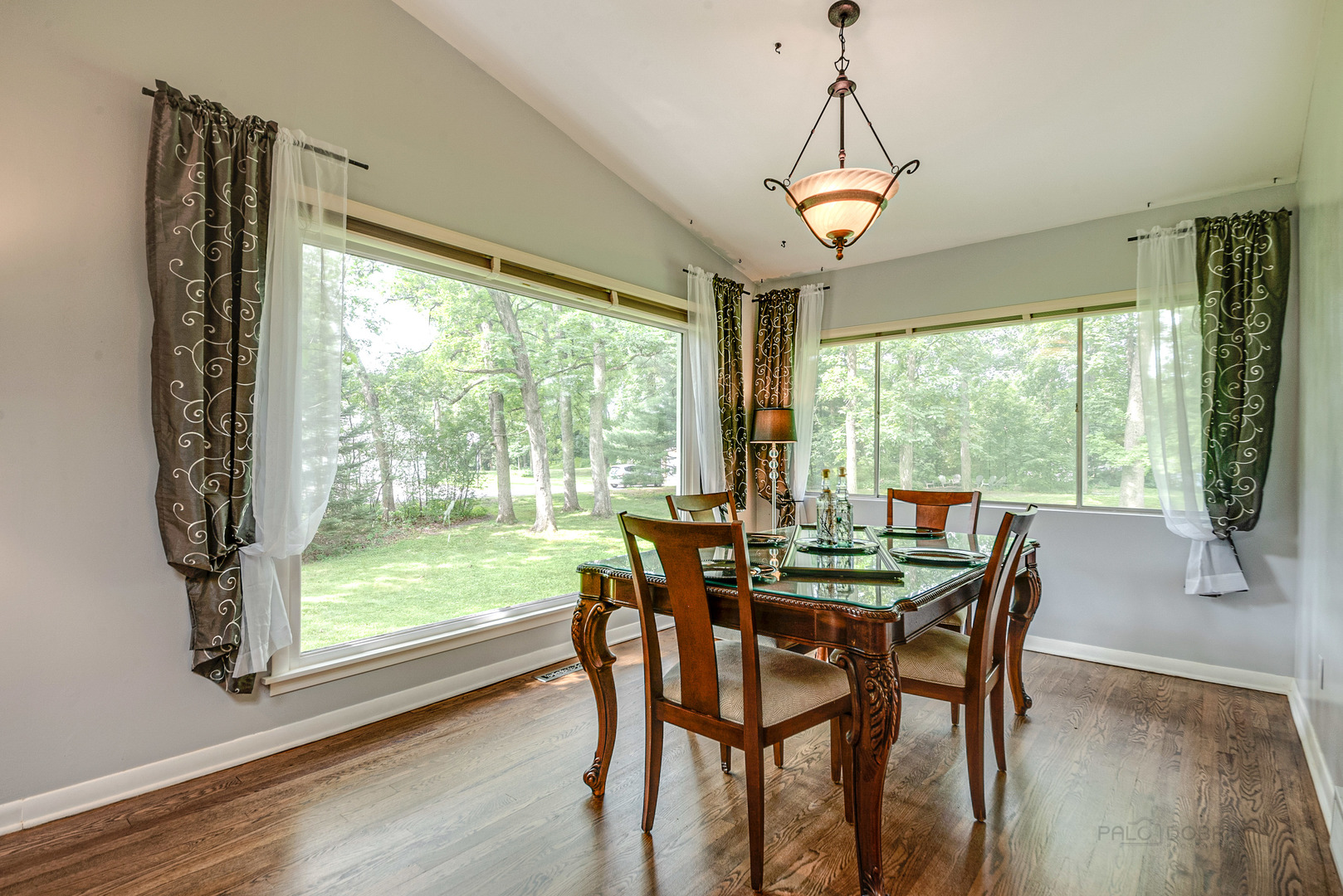 703 Hickory Road Woodstock, IL 60098 - Photo 10 of 33 a dining room with furniture window and wooden floor