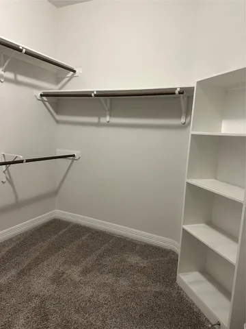 a bathroom with a granite countertop toilet sink and mirror
