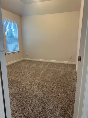 an empty room with closet area