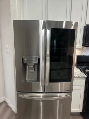 a kitchen with stainless steel appliances kitchen island granite countertop a refrigerator and a stove top oven