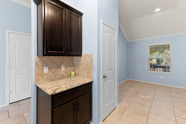 a kitchen with stainless steel appliances kitchen island granite countertop a refrigerator and a sink