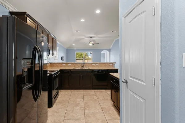 a kitchen with a sink stainless steel appliances and cabinets