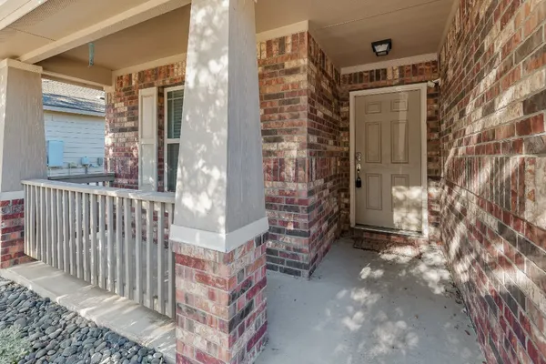 a view of a hallway with chandelier and closet area