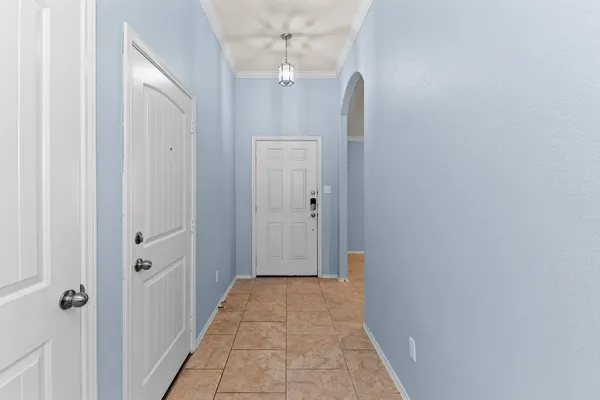 a view of a hallway with wooden floor and a living room