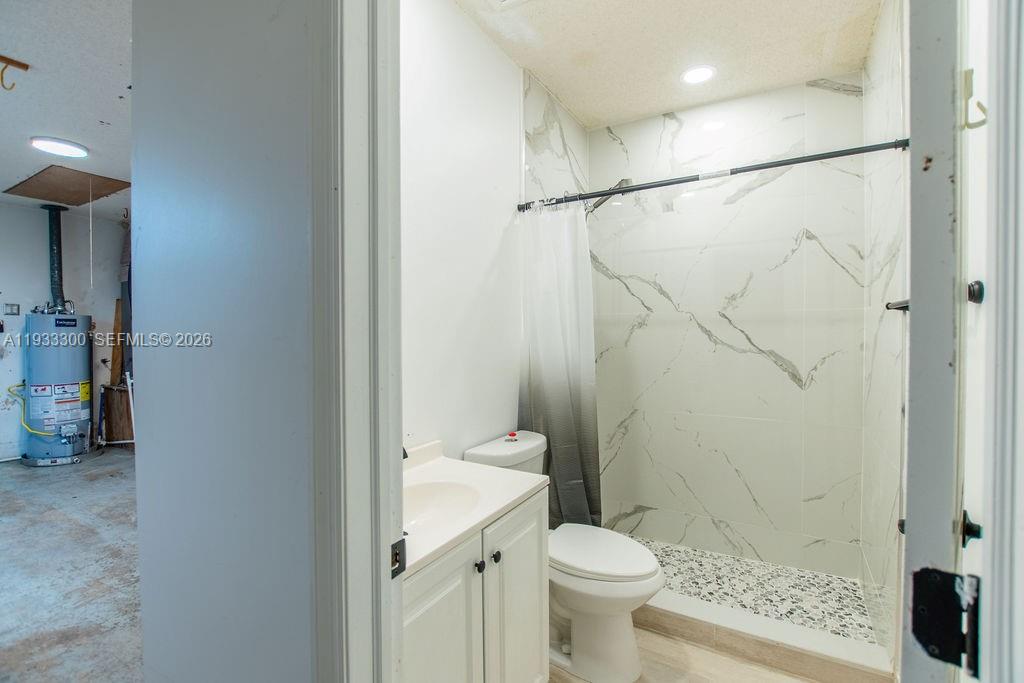 11751 Northwest 32nd Manor Sunrise, FL 33323 - Photo 11 of 32 a bathroom with a shower and a toilet