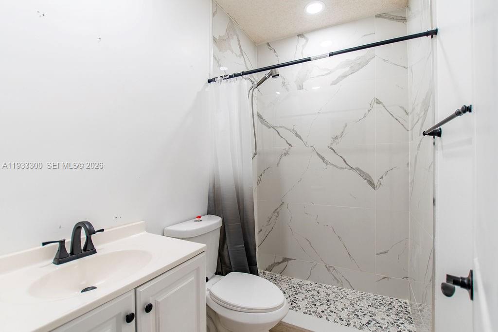 11751 Northwest 32nd Manor Sunrise, FL 33323 - Photo 12 of 32 a bathroom with a sink toilet and shower