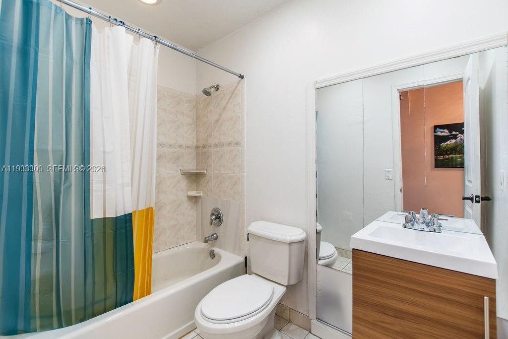 11751 Northwest 32nd Manor Sunrise, FL 33323 - Photo 15 of 32 a bathroom with a sink a toilet and shower