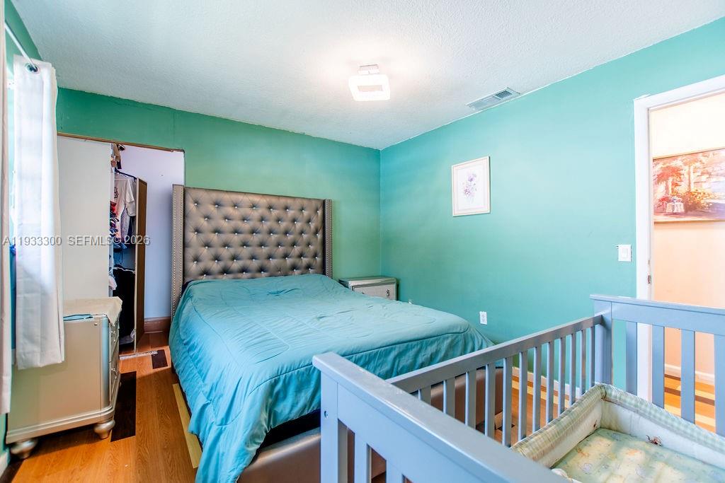11751 Northwest 32nd Manor Sunrise, FL 33323 - Photo 20 of 32 a bedroom with furniture and a window