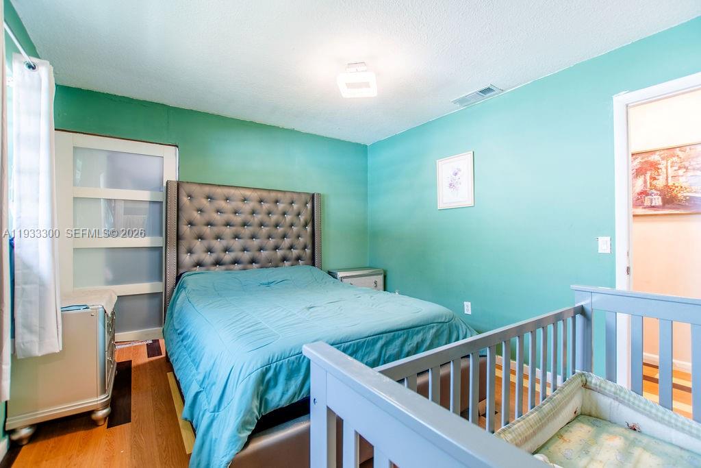 11751 Northwest 32nd Manor Sunrise, FL 33323 - Photo 21 of 32 a bedroom with furniture and a window