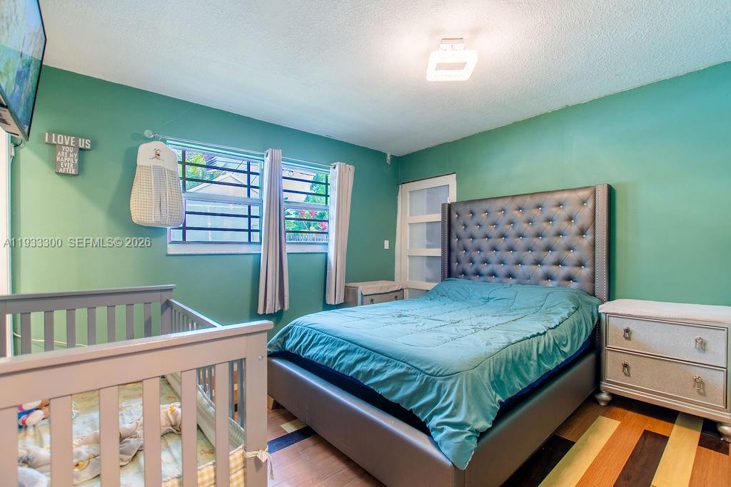 11751 Northwest 32nd Manor Sunrise, FL 33323 - Photo 23 of 32 a bedroom with a bed and a window