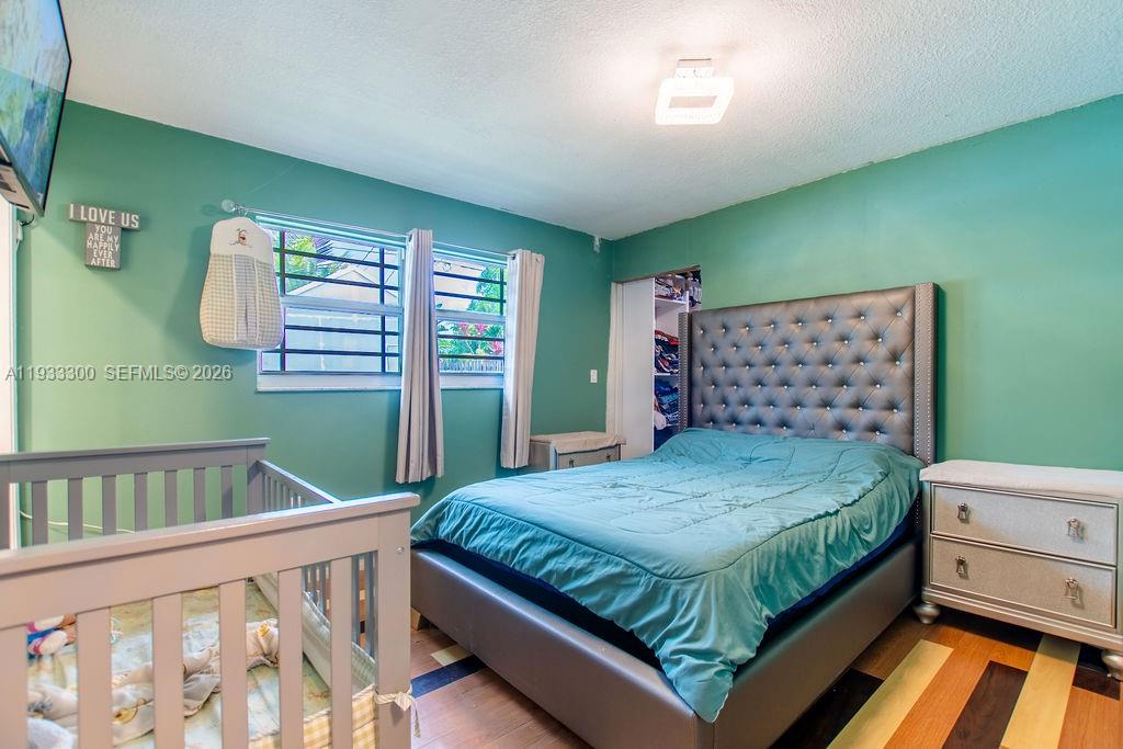 11751 Northwest 32nd Manor Sunrise, FL 33323 - Photo 24 of 32 a bedroom with a bed and a window