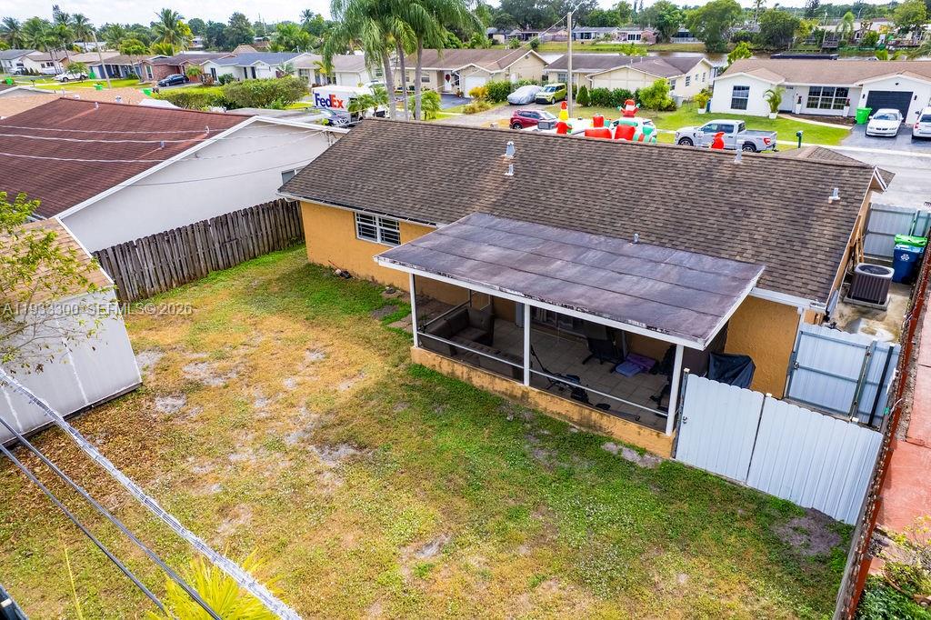 11751 Northwest 32nd Manor Sunrise, FL 33323 - Photo 28 of 32 a view of a swimming pool with a patio and yard