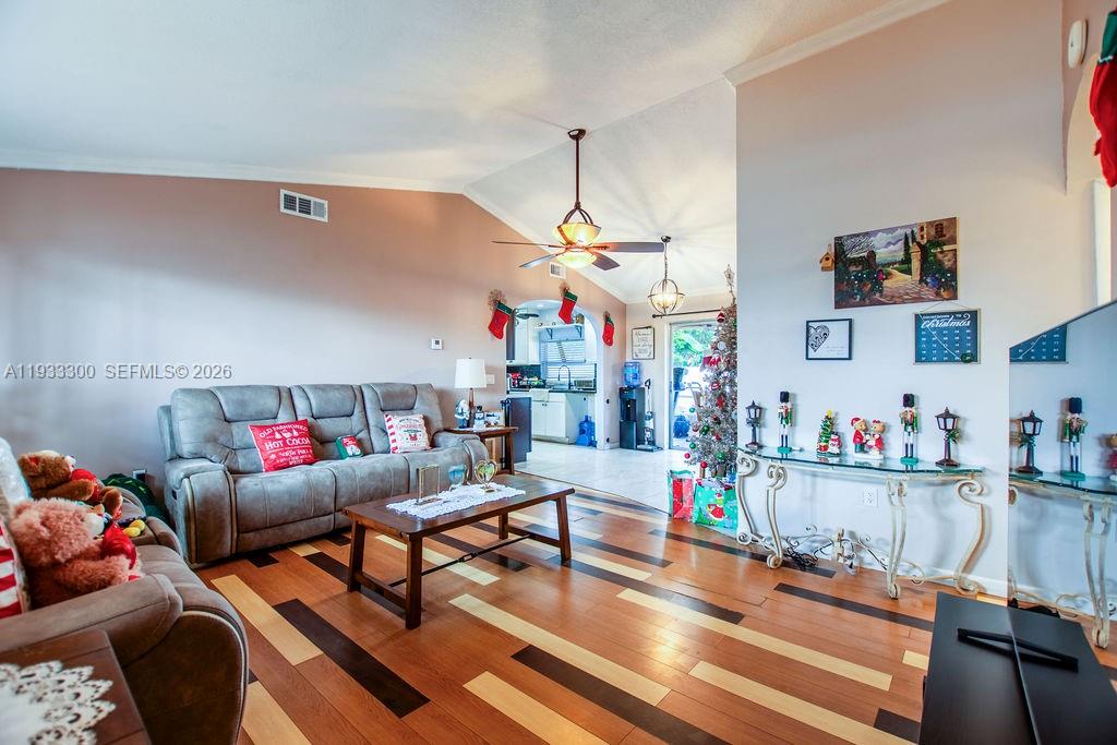 11751 Northwest 32nd Manor Sunrise, FL 33323 - Photo 3 of 32 a living room with lots of furniture and clutter