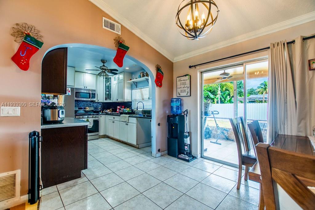 11751 Northwest 32nd Manor Sunrise, FL 33323 - Photo 7 of 32 a kitchen view of a dining table chairs and entryway