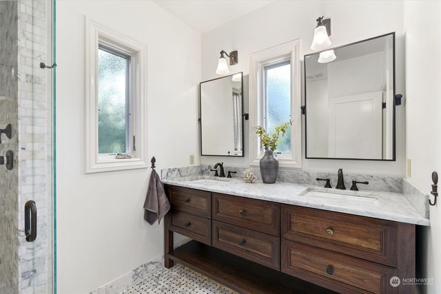 a bathroom with a double vanity sink and mirror