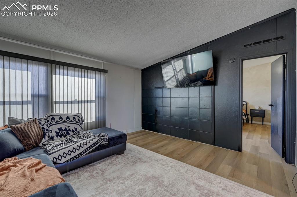 21050 McDaniels Road Calhan, CO 80808 - Photo 12 of 46 a spacious bedroom with a large bed and a couch