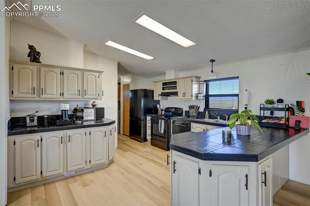 21050 McDaniels Road Calhan, CO 80808 - Photo 14 of 46 a kitchen with granite countertop a sink a counter space appliances and cabinets