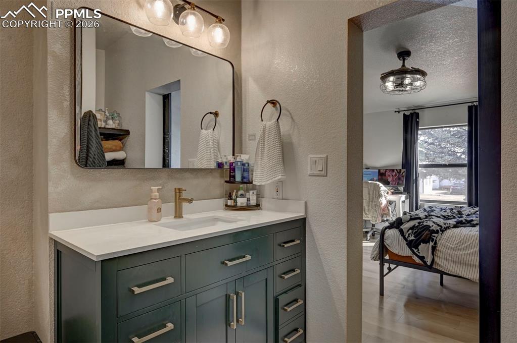 21050 McDaniels Road Calhan, CO 80808 - Photo 25 of 46 a en suite bathroom with a double vanity sink and a mirror