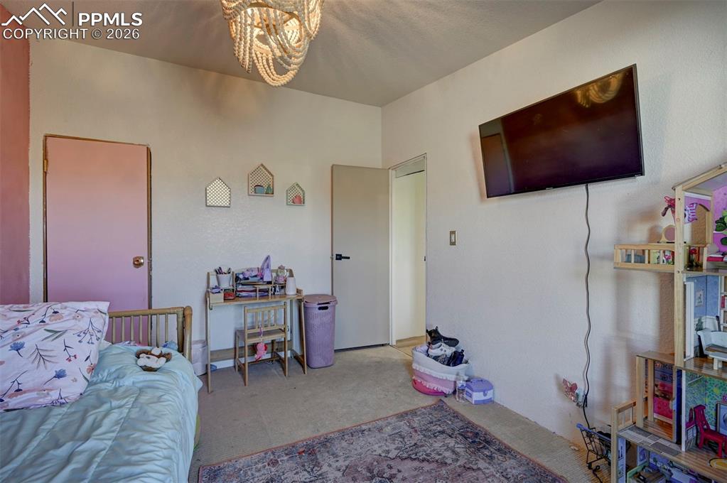 21050 McDaniels Road Calhan, CO 80808 - Photo 30 of 46 a living room with furniture and a flat screen tv