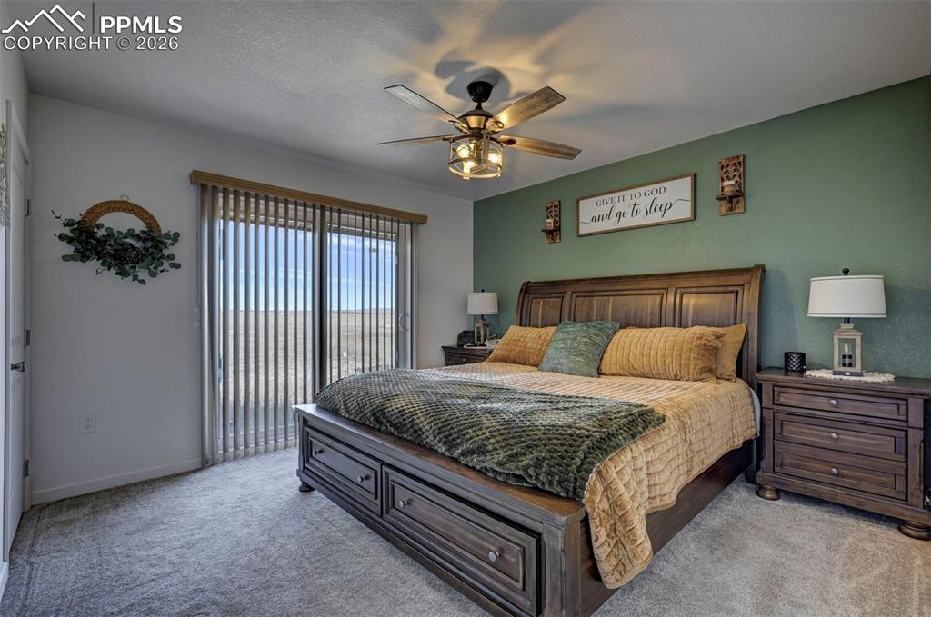 21050 McDaniels Road Calhan, CO 80808 - Photo 44 of 46 a bed room with a bed and a chandelier