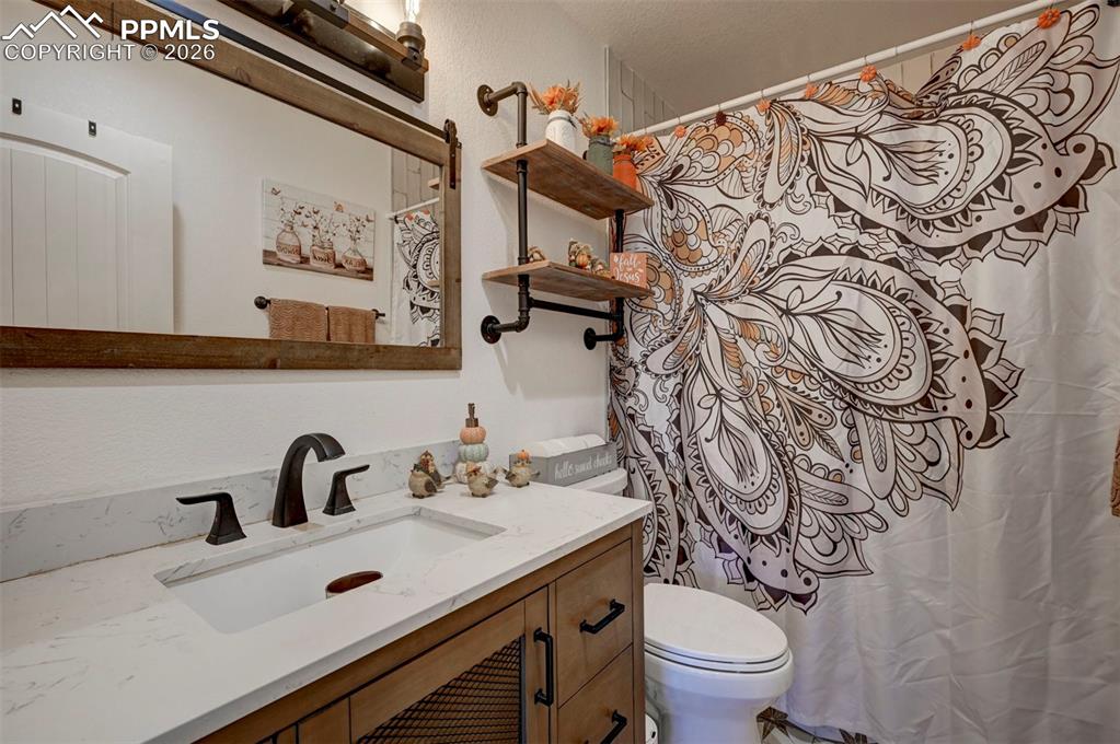 21050 McDaniels Road Calhan, CO 80808 - Photo 46 of 46 a bathroom with a sink and mirror with toilet