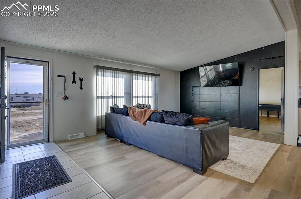 21050 McDaniels Road Calhan, CO 80808 - Photo 10 of 46 a living room with furniture and a rug