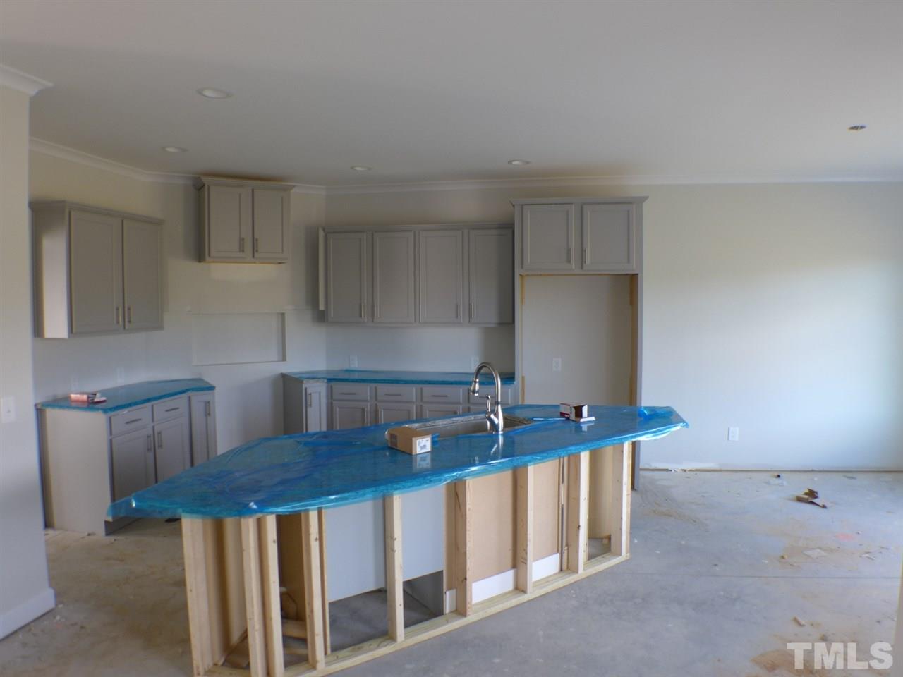 2589 Stanley Hall Road Dunn, NC 28334 - Photo 5 of 13 a kitchen with stainless steel appliances granite countertop a sink a stove and white cabinets