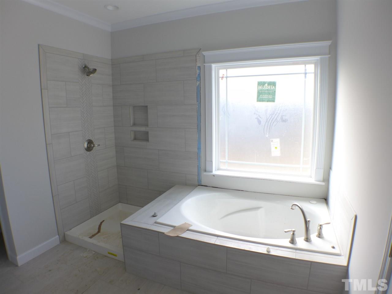 2589 Stanley Hall Road Dunn, NC 28334 - Photo 8 of 13 a bathroom with a bathtub and window