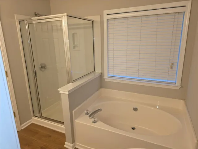 a bathroom with a bathtub and a shower