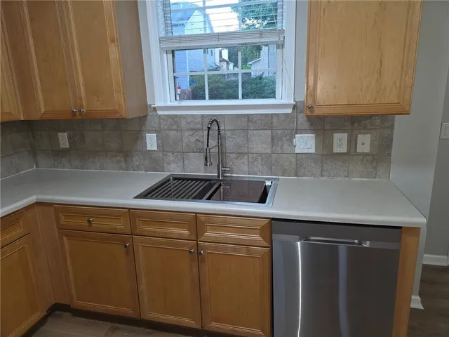 a kitchen with a sink cabinets and window