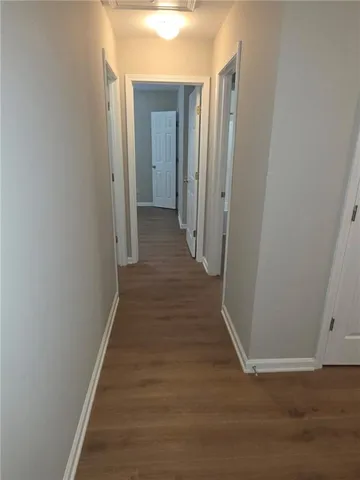 a view of a hallway with wooden floor