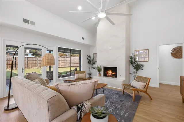 a spacious bedroom with a bed a couch and paintings on the wall