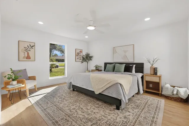 a spacious bedroom with a bed and a chandelier