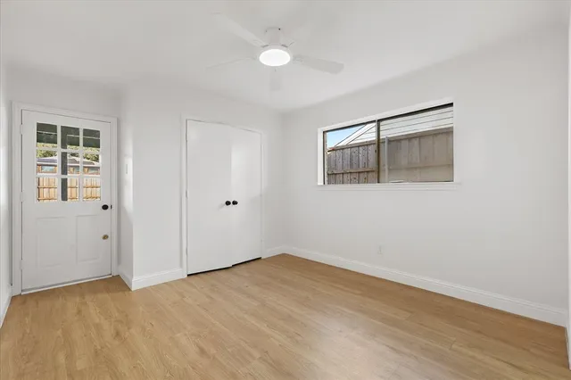 a view of a room with wooden floor and entryway