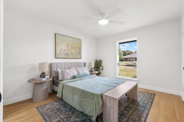 a bedroom with a bed and a painting on the wall