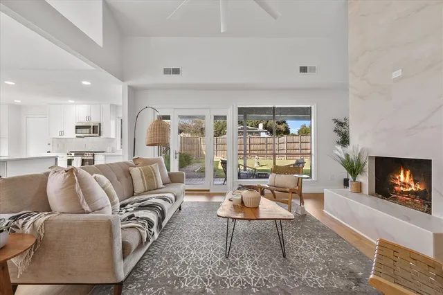 a kitchen with stainless steel appliances kitchen island granite countertop a stove a sink and a refrigerator