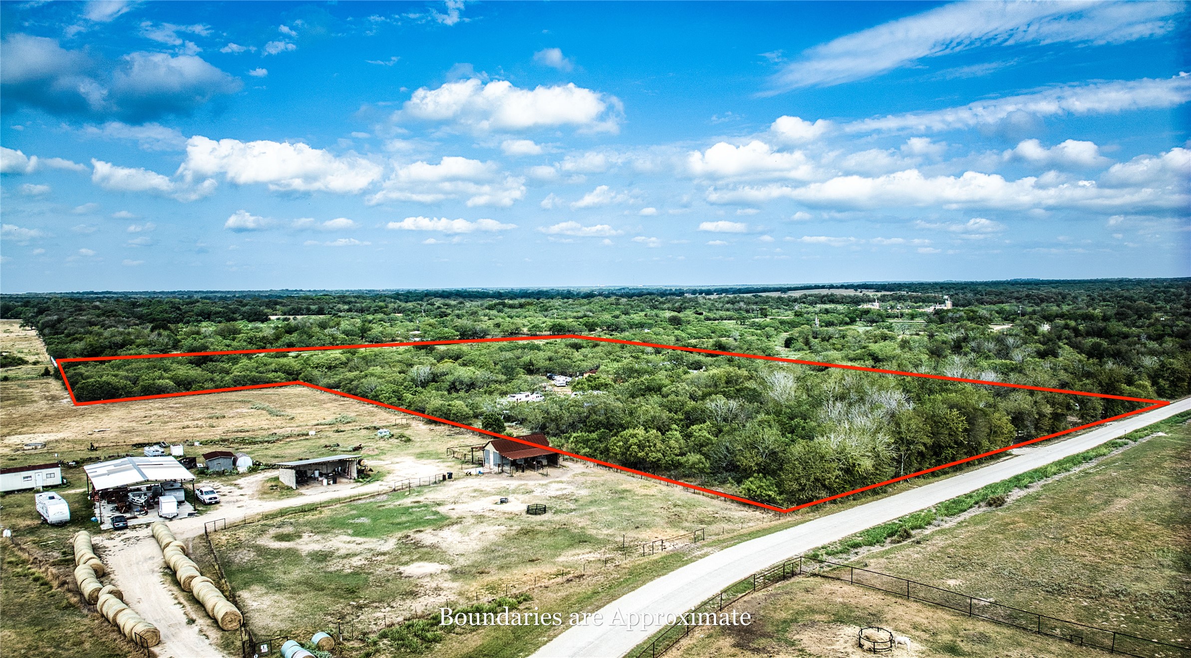 2900 Salt Flat Road Luling, TX 78648 - Photo 16 of 17 Lush woodlands stretch across the landscape under a wide blue sky.