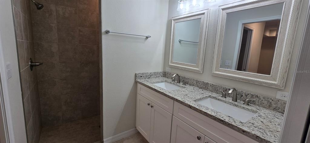 16263 Southwest 48th Circle Ocala, FL 34473 - Photo 13 of 16 a bathroom with a granite countertop sink and a mirror