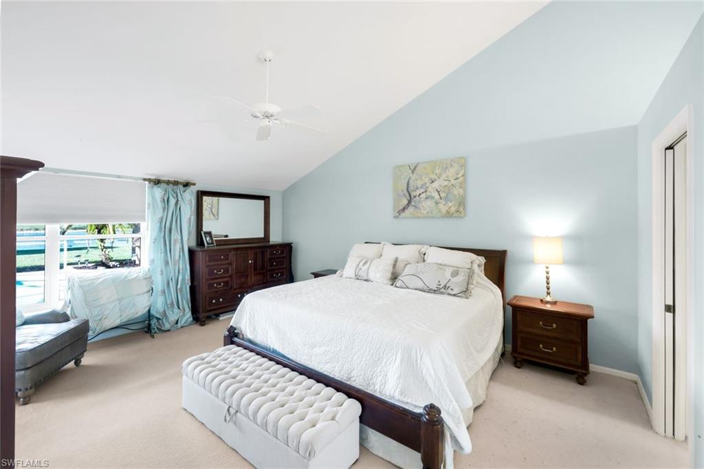 11822 Quail Village Way Naples, FL 34119 - Photo 12 of 34 a spacious bedroom with a bed and a view of bathroom