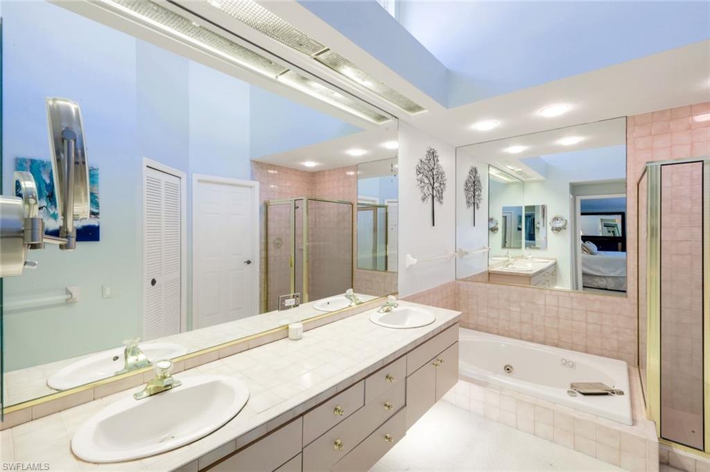 11822 Quail Village Way Naples, FL 34119 - Photo 13 of 34 a bathroom with a granite countertop double vanity sink and a large mirror