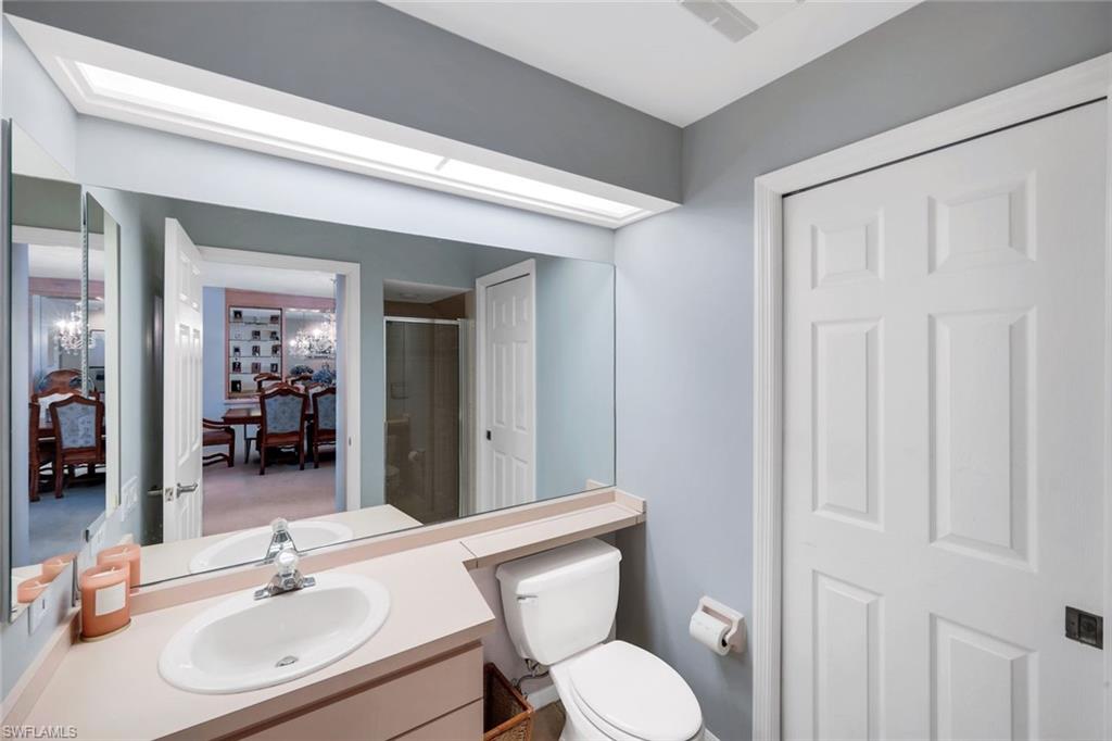 11822 Quail Village Way Naples, FL 34119 - Photo 15 of 34 a bathroom with a sink and a mirror