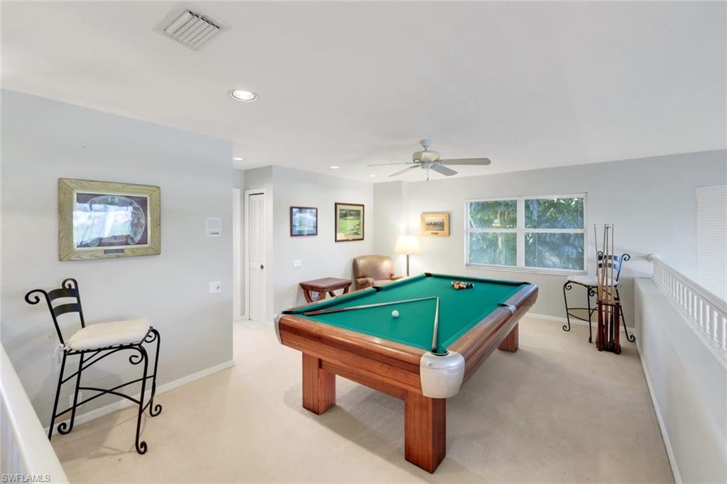 11822 Quail Village Way Naples, FL 34119 - Photo 16 of 34 a room with furniture and a window