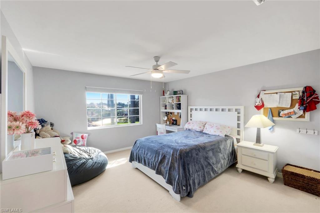 11822 Quail Village Way Naples, FL 34119 - Photo 18 of 34 a bedroom with a bed and a couch