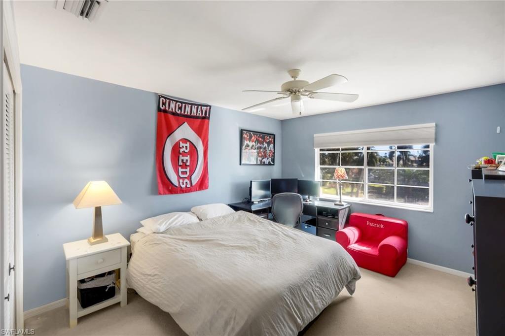 11822 Quail Village Way Naples, FL 34119 - Photo 20 of 34 a bedroom with bed and a window