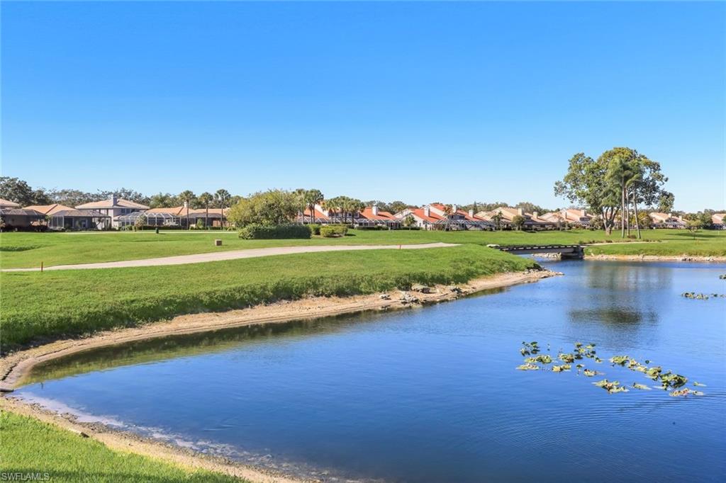 11822 Quail Village Way Naples, FL 34119 - Photo 25 of 34 a view of a lake with a big yard