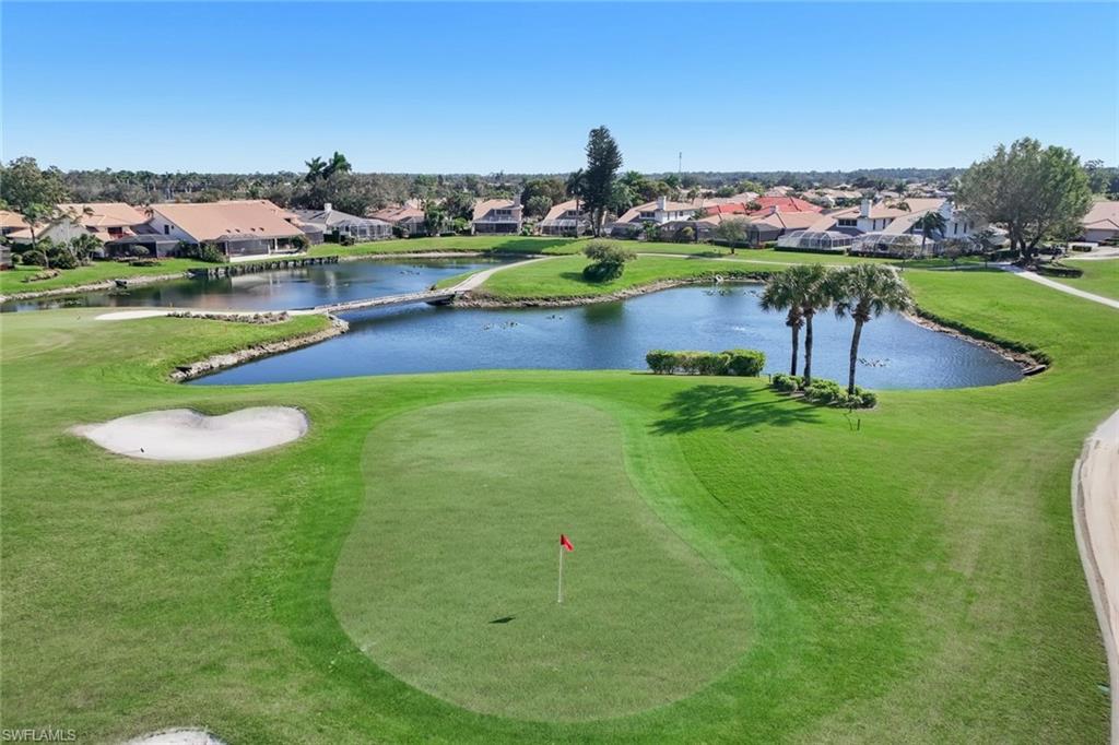 11822 Quail Village Way Naples, FL 34119 - Photo 26 of 34 a view of a lake with a yard